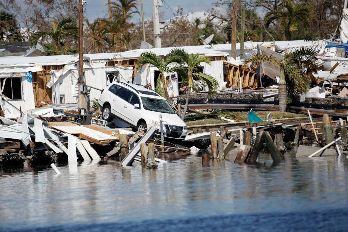 A destroyed car is seen in the Matanzas Pass after Hurricane Ian caused widespread destruction in Fort Myers Beach, Florida, U.S., October 1, 2022. REUTERS/Marco Bello - RC2BSW95BDVH