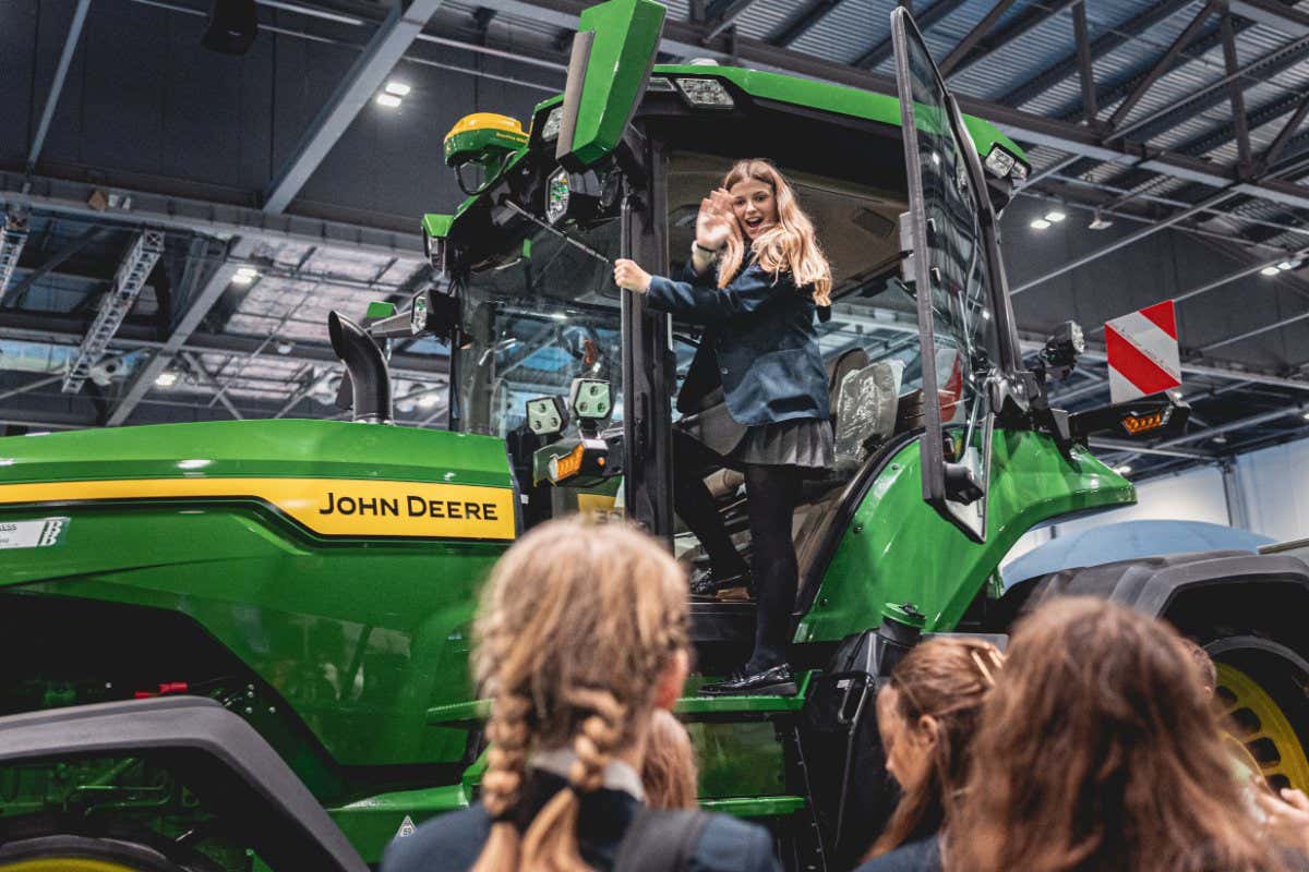 Visitor climbing into the John Deere tractor