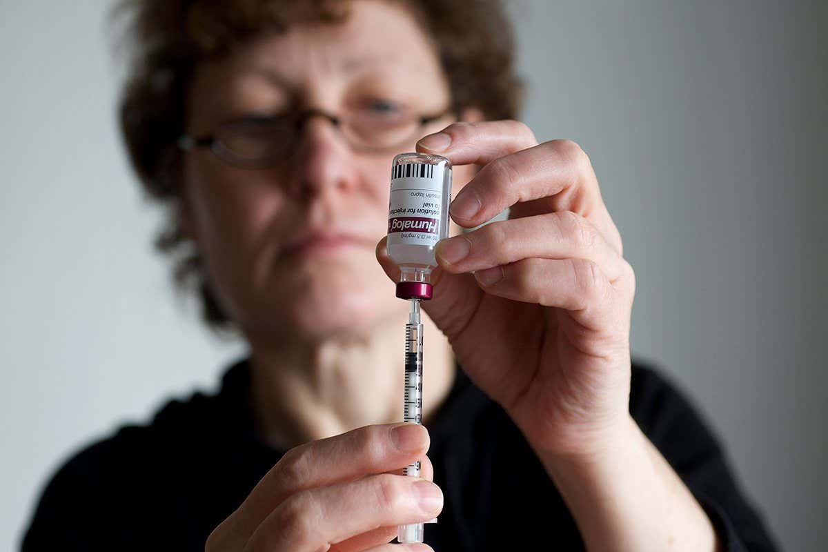 A woman drawing insulin from a syringe