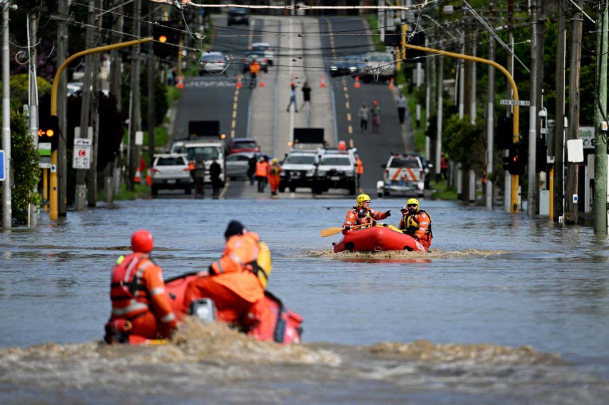 Emergency workers patrol a flooded area in Melbourne on 14 October