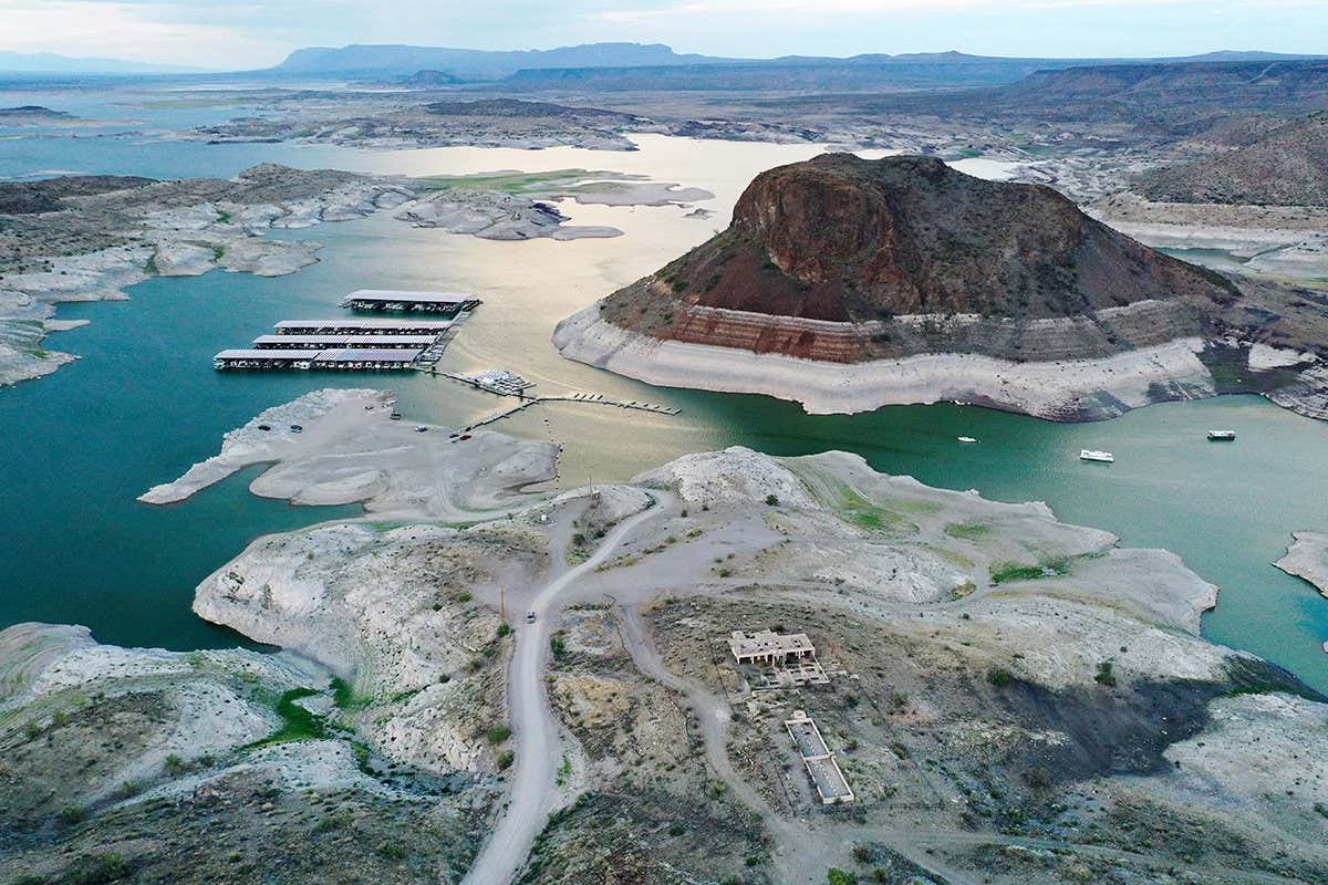 TRUTH OR CONSEQUENCES, NEW MEXICO - AUGUST 15: An aerial view of a 'bathtub ring' of mineral deposits left by higher water levels at the drought-stricken Elephant Butte Reservoir on August 15, 2022 near Truth or Consequences, New Mexico. New Mexico?s largest reservoir is currently at 3.8 percent of its total capacity in spite of recent monsoon rains in the state. According to officials, water levels at Elephant Butte have been below average since around 2019 and the lake has not been able to meet full levels of irrigation demand for several years. Experts say that in spite of the monsoon rains bringing temporary relief to parts of the Southwest, the climate change-fueled megadrought remains entrenched in the West. (Photo by Mario Tama/Getty Images)