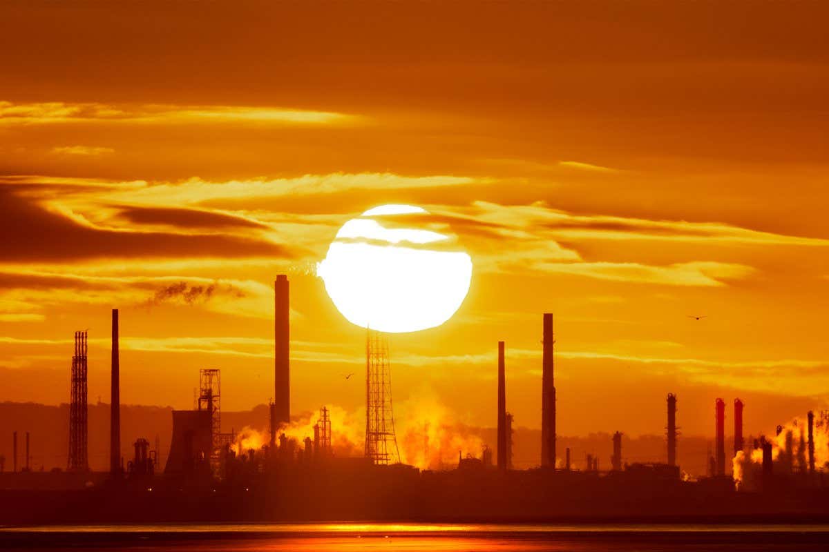 Power station chimneys in front of sunrise