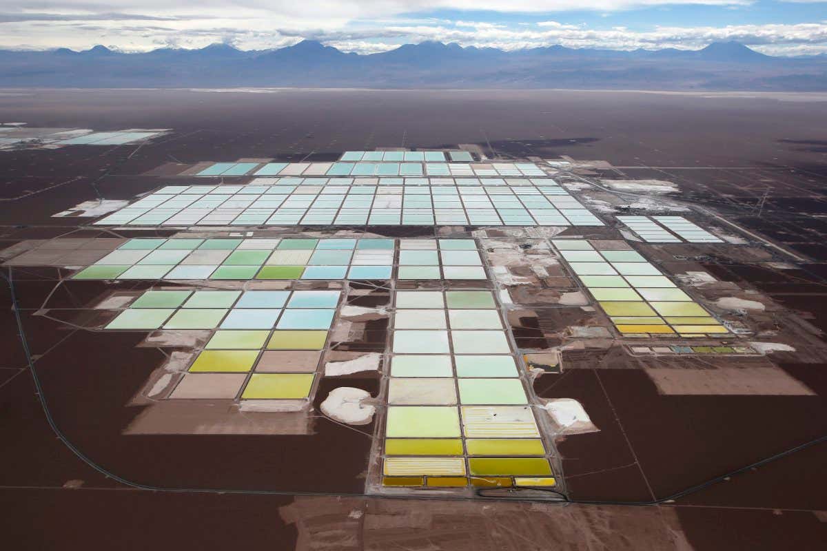 An aerial view shows the brine pools and processing areas of the Soquimich (SQM) lithium mine on the Atacama salt flat, the world's second largest salt flat and the largest lithium deposit currently in production, with over a quarter of the world's known reserves, in the Atacama desert of northern Chile, January 10, 2013. SQM fertilizer company has fired its chief executive after it became embroiled in an election campaign financing scandal that has rocked the Chilean establishment, tainting business leaders and politicians with close links to the 1973-1990 dictatorship of Augusto Pinochet. Picture taken January 10, 2013. REUTERS/Ivan Alvarado (CHILE - Tags: SOCIETY BUSINESS ENVIRONMENT POLITICS) - GM1EB3I04EU01