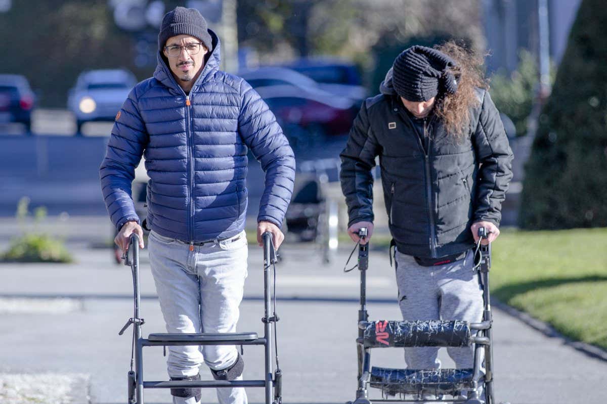 Two people with lower body paralysis can walk further after receiving electrical stimulation to the injured area of their spine