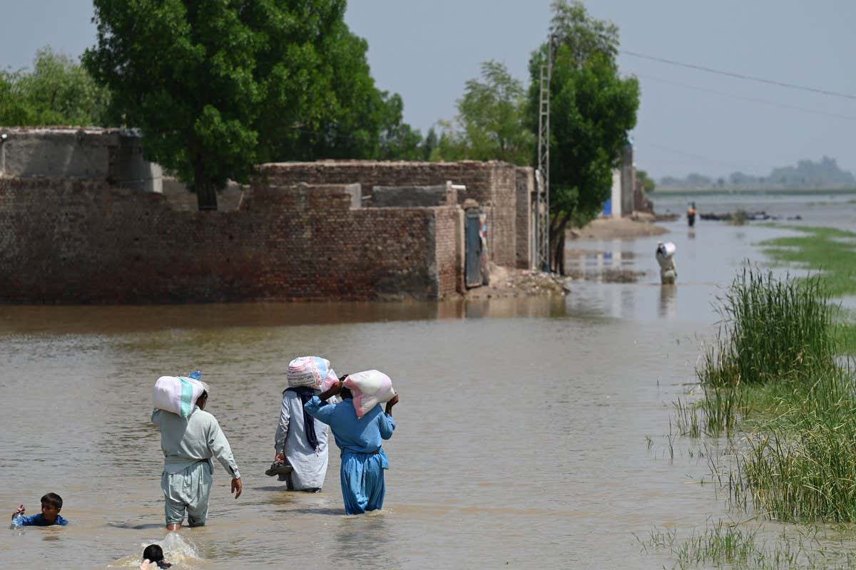 People walking through floodwater