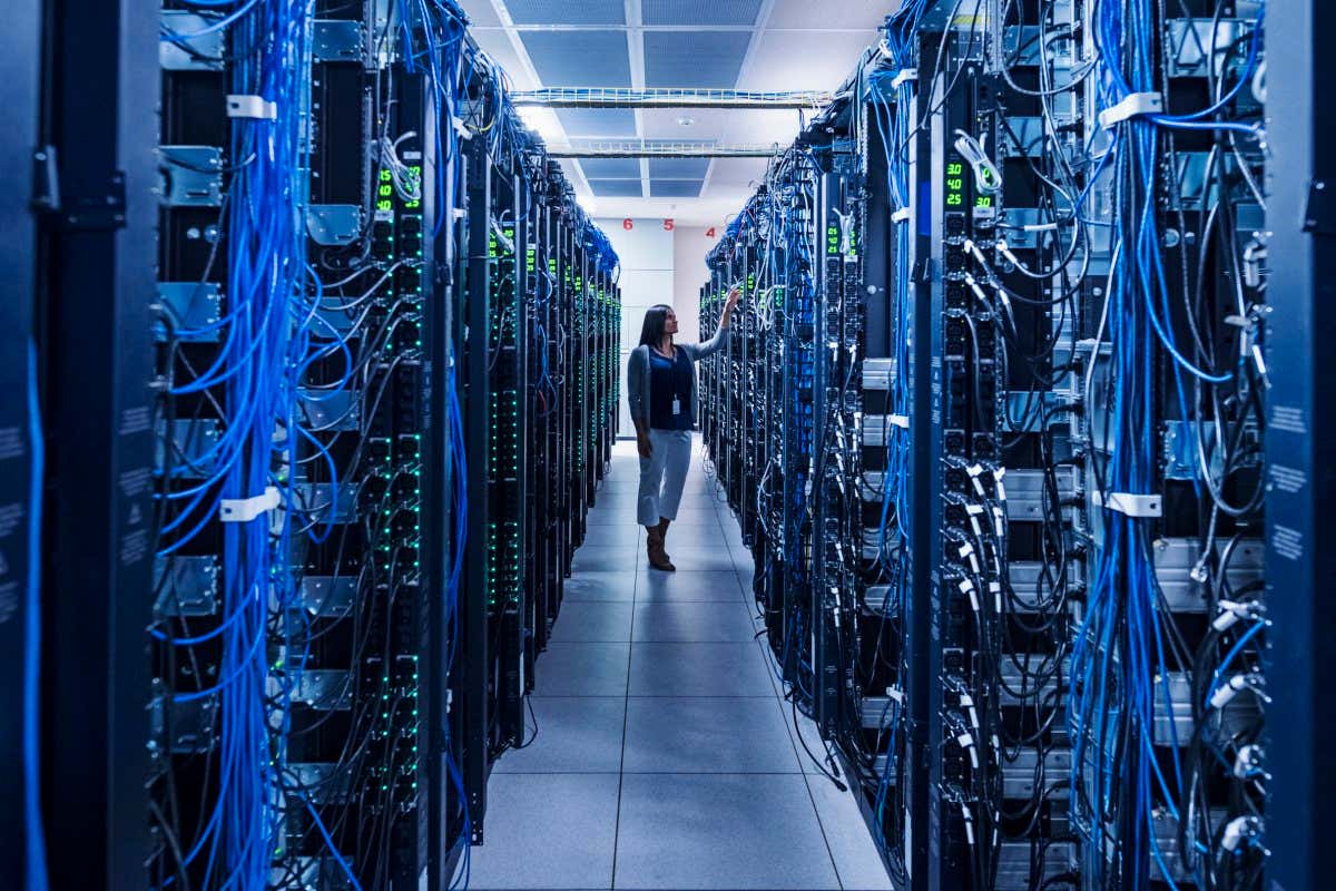 Woman standing in aisle of server room