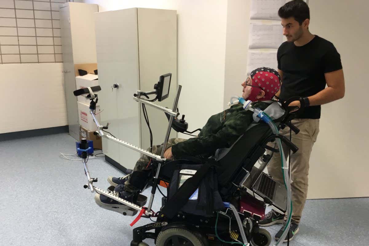 A person with tetraplegia uses a mind-controlled wheelchair as part of a trial