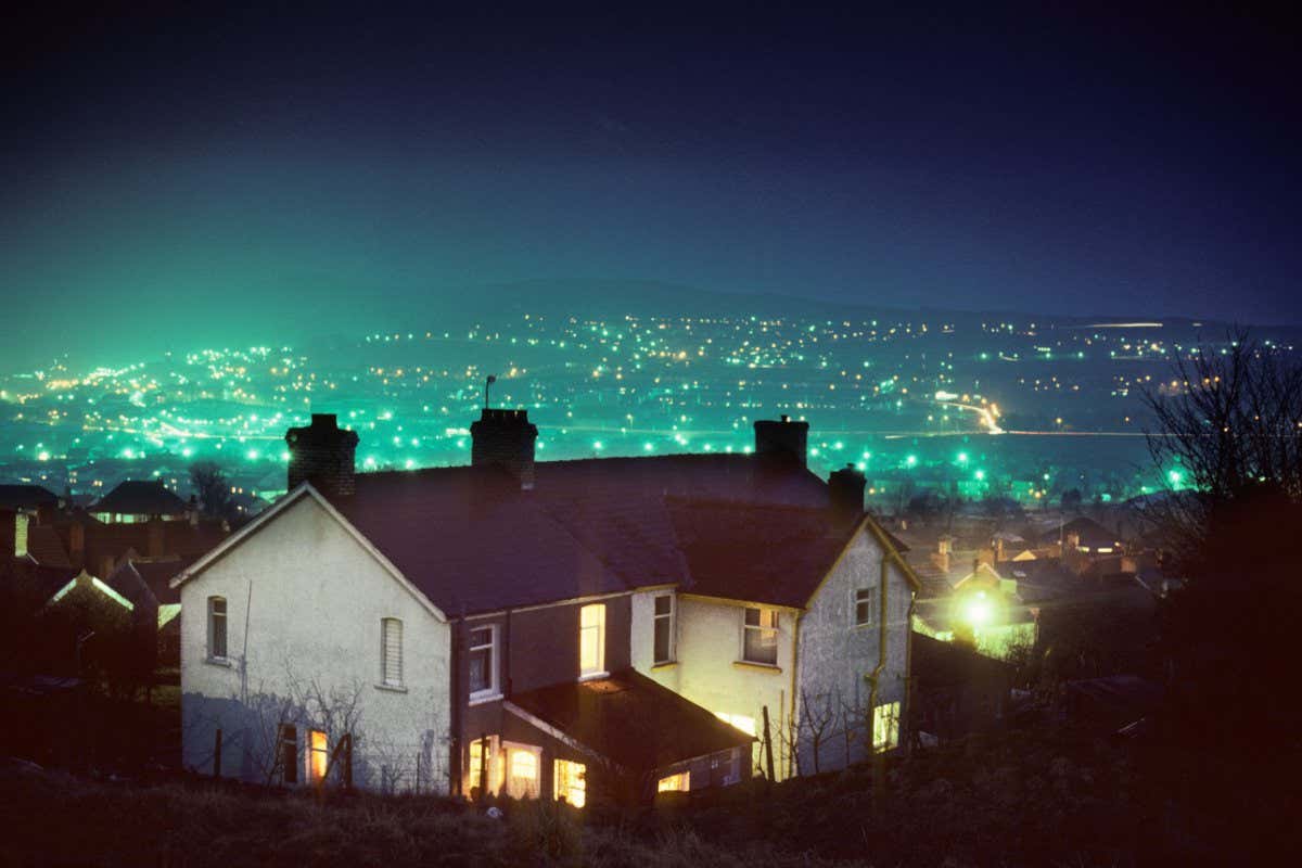 A4HEEB House at Ebbw Vale at night with light pollution from street lights in distance South Wales UK