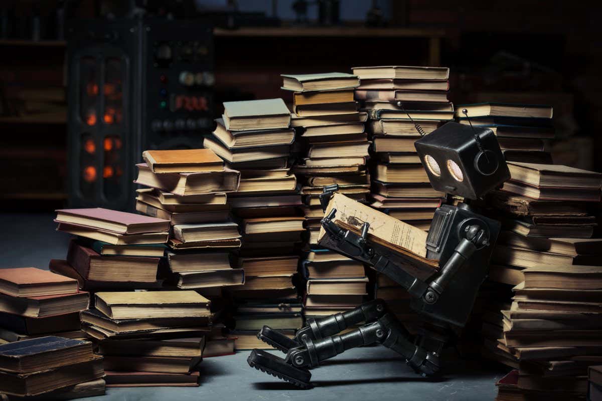 Robot-child reading a book in the workshop of its creator; Shutterstock ID 289821398; purchase_order: -; job: -; client: -; other: -