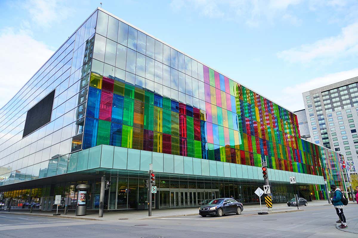 MONTREAL, CANADA -17 OCT 2018- View of colorful glass panes on the Palais des Congres convention and exhibition center in Montreal, located on Place Jean-Paul Riopelle next to Chinatown.