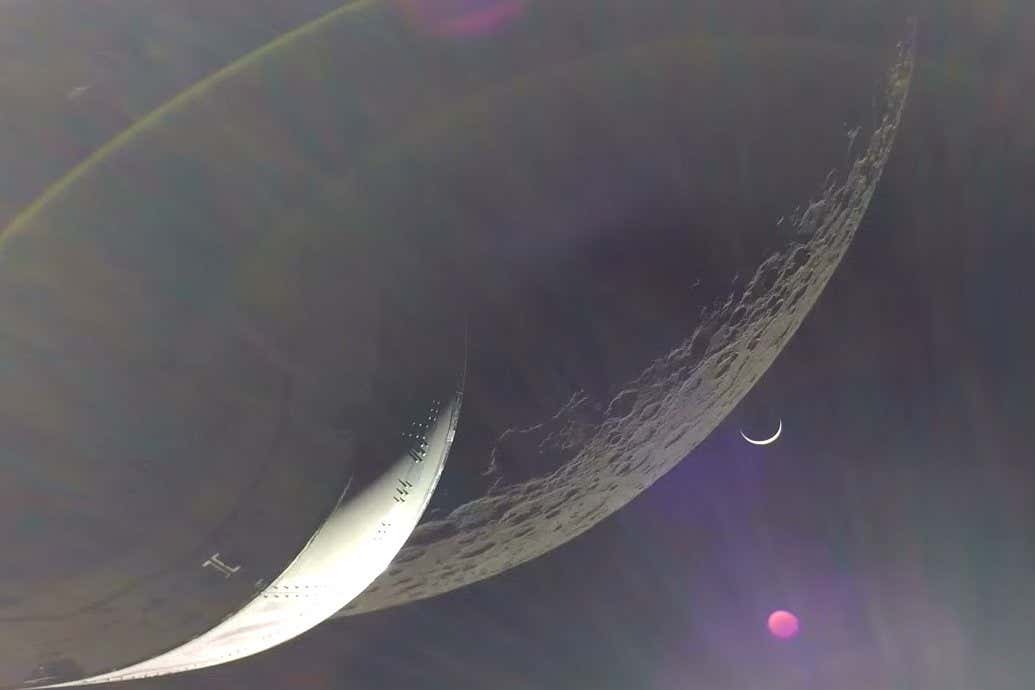 A view of Earth rising over the moon from the Orion capsule