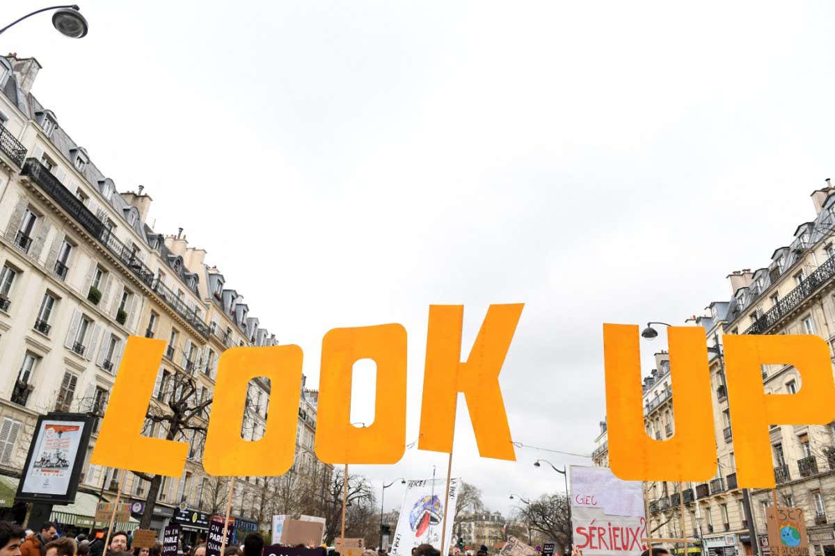 Protesters hold placards during a 