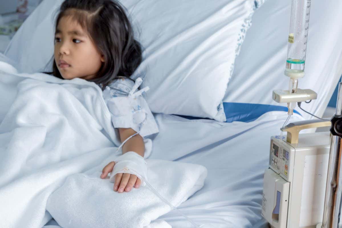 A child sitting in a hospital bed