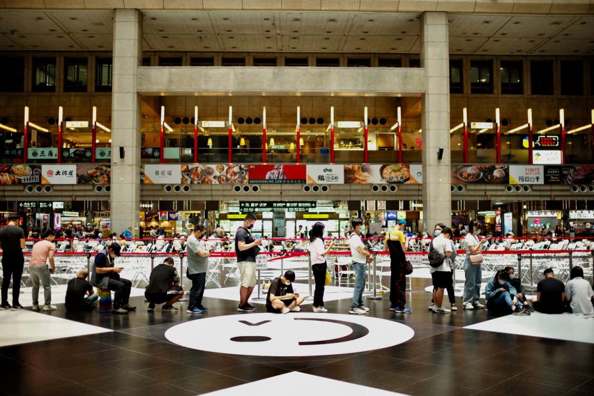 People queue up to receive the Medigen and Moderna vaccines for the Covid-19 coronavirus at Taipei's main train station on April 29, 2022. (Photo by Sam Yeh / AFP) (Photo by SAM YEH/AFP via Getty Images)