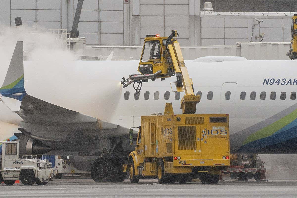 An Alaska Airlines plane being deiced in Seattle on Tuesday 20 December