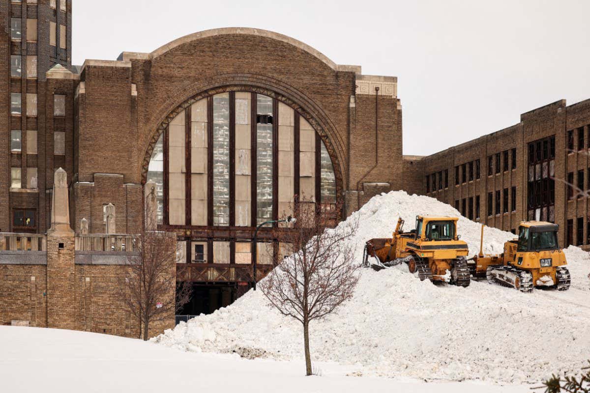 Bulldozers on a large pile of snow