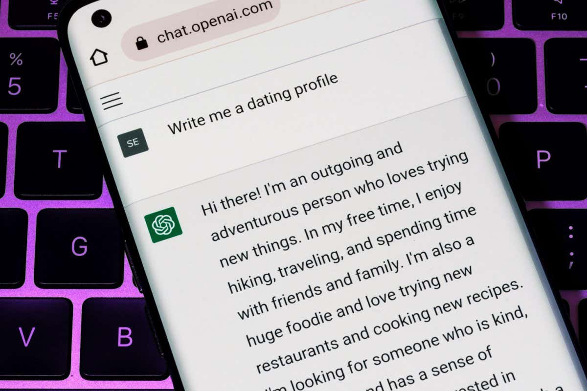 2M3C0HG OPEN AI ChatGPT chat bot seen on smartphone placed on laptop. AI chatbot responded to the request to write a dating profile. Stafford, United Kingdom,