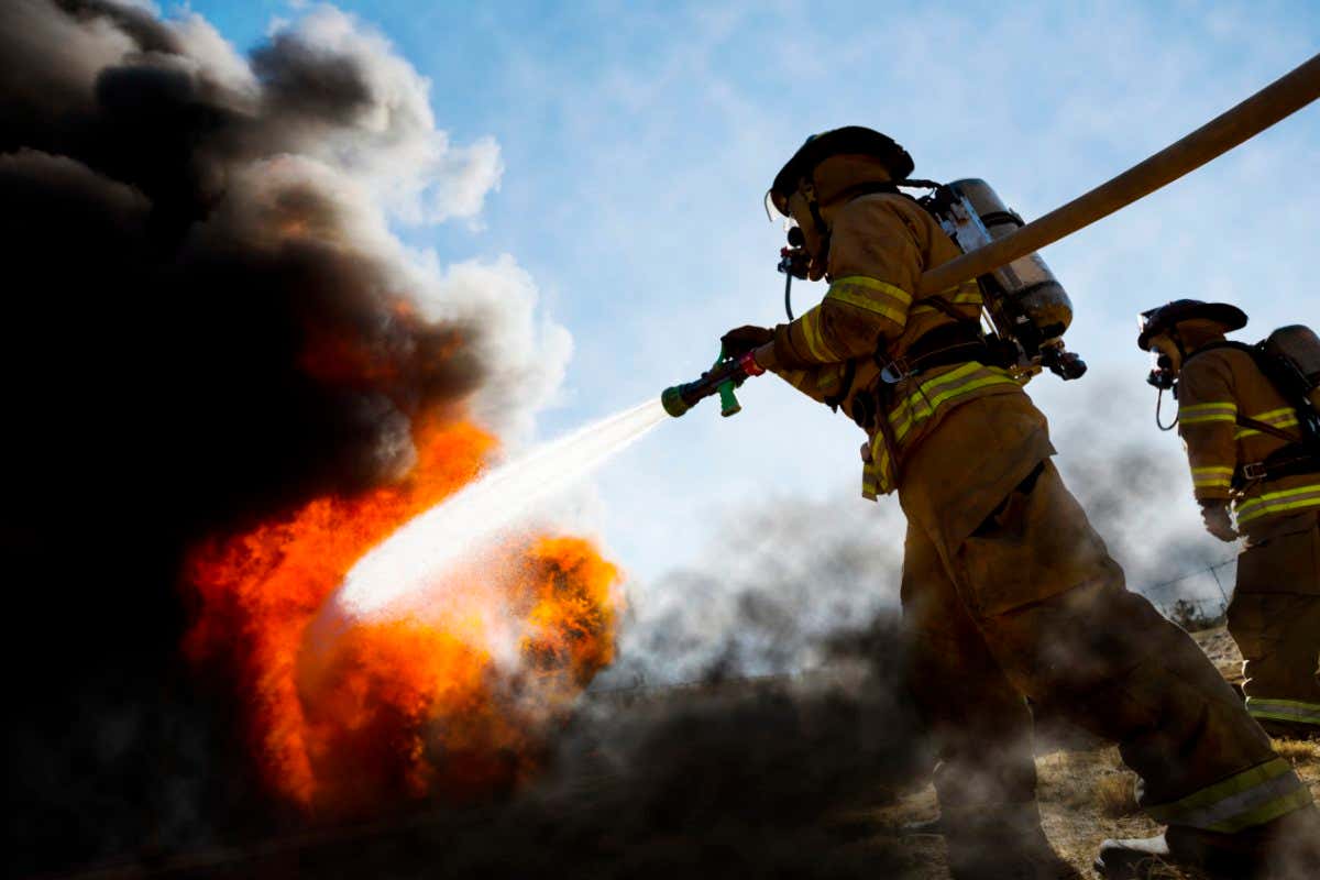 Firefighters extinguishing a house fire