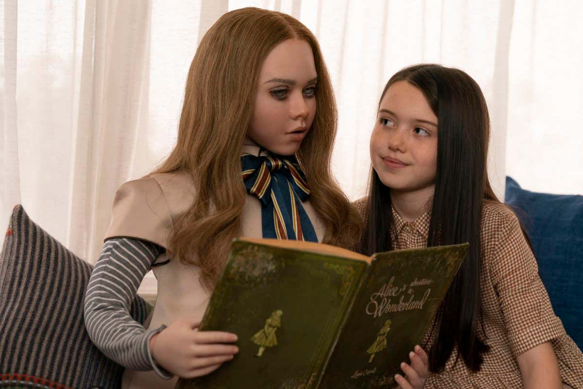 (from left) M3GAN and Cady (Violet McGraw) in M3GAN, directed by Gerard Johnstone.