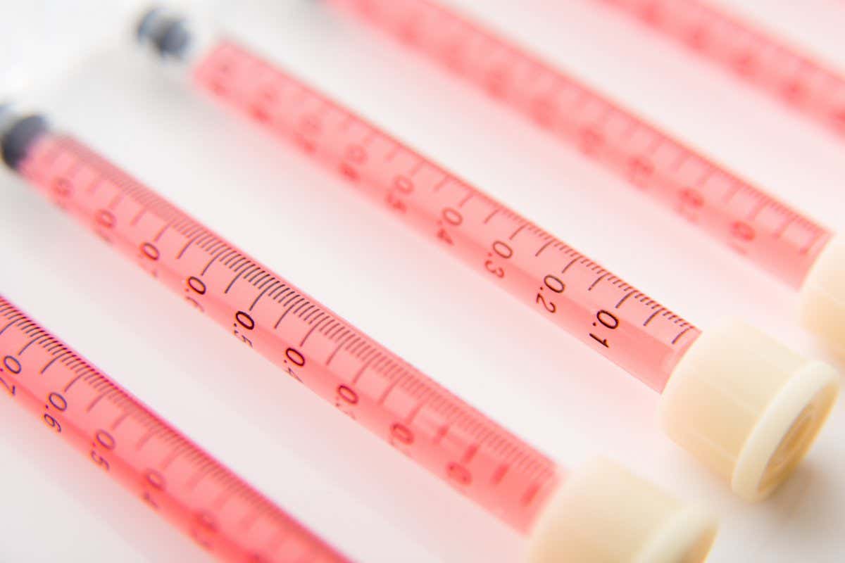 Seven Oral Dispensers with Pink Colored Medicine ; Shutterstock ID 360090797; purchase_order: -; job: -; client: -; other: -