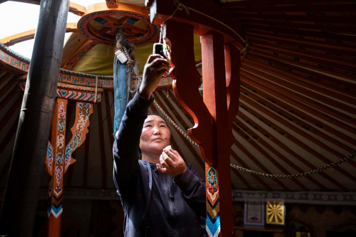 Mongolia - Bayankhongor province - Orkhontuya Oidovdagva (Orkhoo) 38 answers the phone from the center of the ger, the only place that has reception, where the family cell phone is left to hang 24/7.