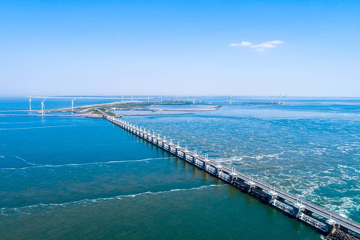 Oosterschelde flood barrier with windmills in the Netherlands at the Northern Sea taken from above with a drone