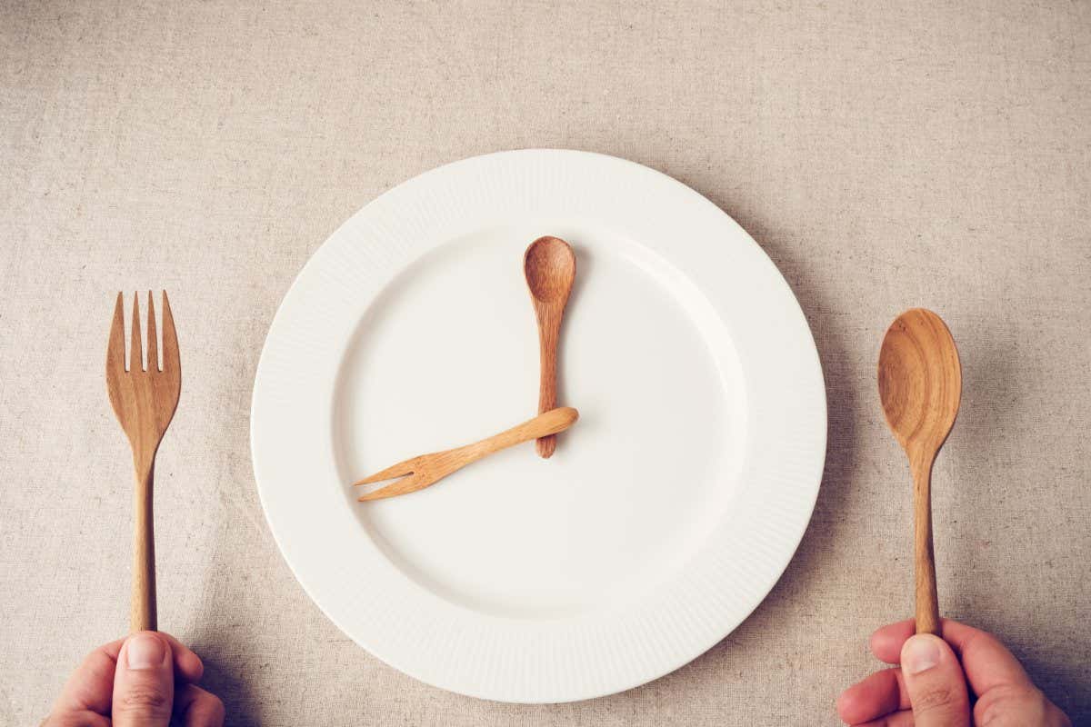 white plate with spoon and fork, Intermittent fasting concept, ketogenic diet, weight loss, food crisis, restaurant and cafe reopening post covid-19 coronavirus pandemic; Shutterstock ID 1027820371; purchase_order: -; job: -; client: -; other: -