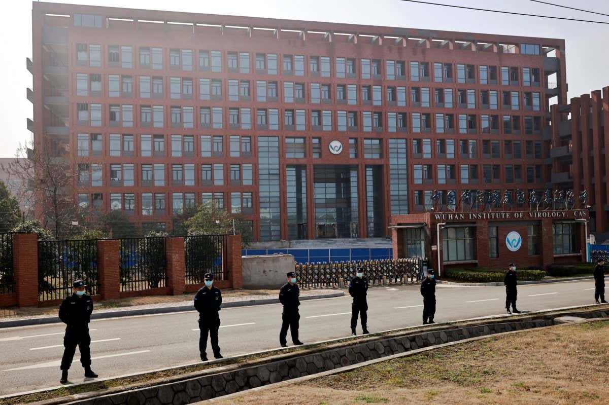 Security personnel keep watch outside Wuhan Institute of Virology during the visit by the World Health Organization (WHO) team tasked with investigating the origins of the coronavirus disease (COVID-19), in??Wuhan, Hubei province, China February 3, 2021. REUTERS/Thomas Peter - RC2TKL9J8J25