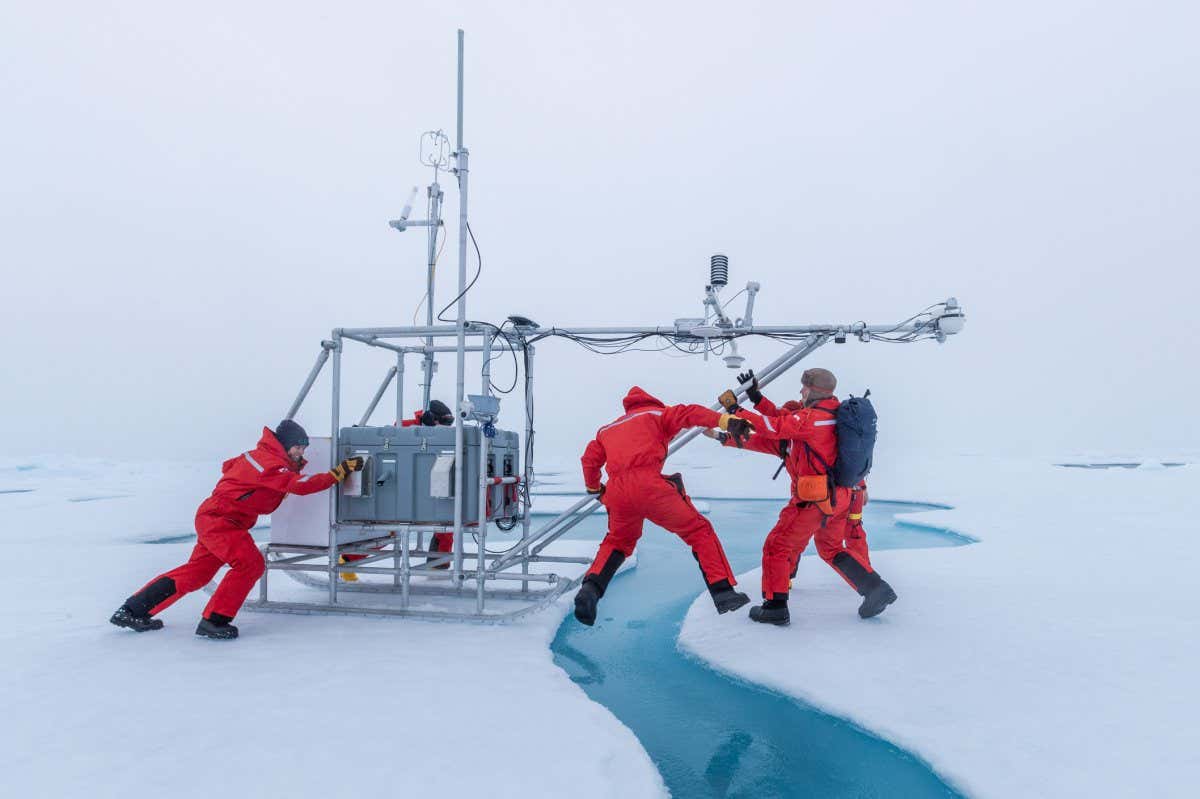 RPS Woman Science Photographer of the Year a small group of atmospheric scientists move a fluxsled to the ice, this was the first instrument deployed on the new MOSAiC floe. ?Leap of Science? by Lianna Nixon (USA)