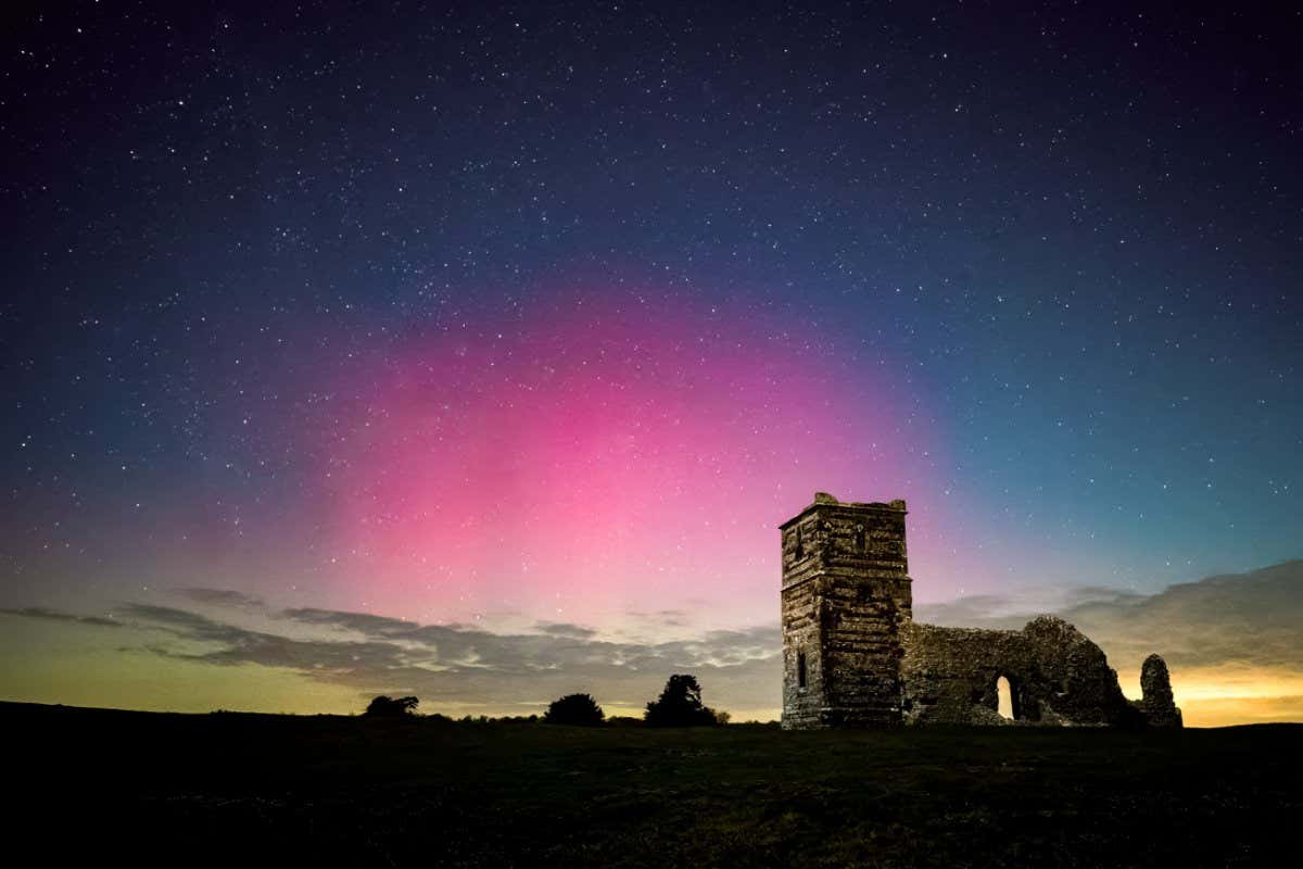 Northern lights, Aurora Borealis, visible over Knowlton Church in Dorset, UK 27th Feb 2023