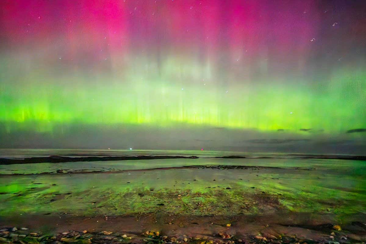 Northern lights, aurora borealis, visible over Hopeman Beach in Scotland on 26 February 2023