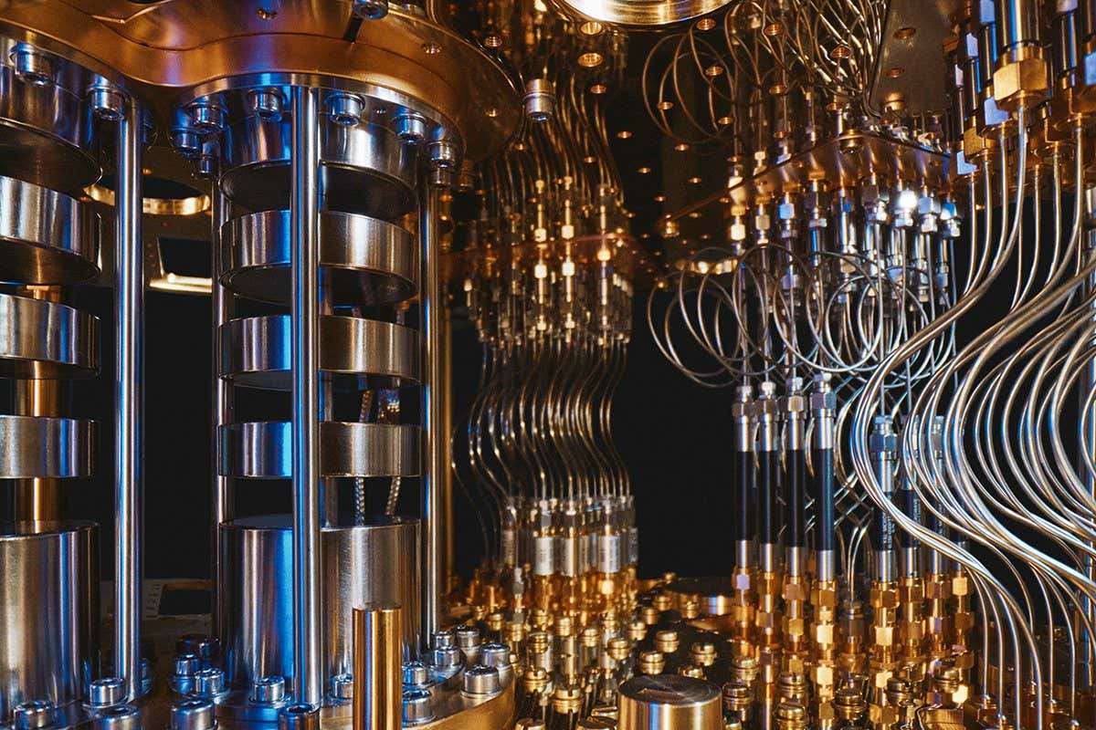 A tightly arranged collection of copper and silver-colored metallic tubes and cylinders comprise the inside of a quantum computer