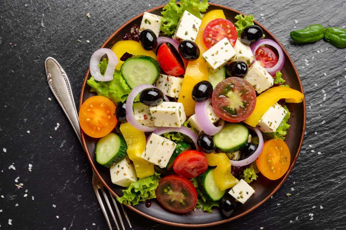 2A6JA2X Top view at Mediterranean diet dish greek salad on slate tray
