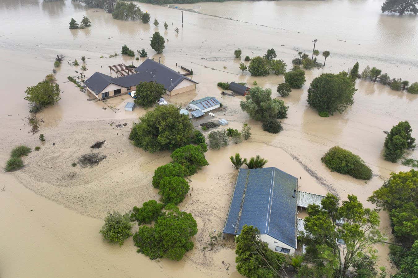 TOPSHOT - An aerial photo taken on February 14, 2023 shows flooding caused by Cyclone Gabrielle in Awatoto, near the city of Napier. - New Zealand declared a national state of emergency on February 14 as Cyclone Gabrielle swept away roads, inundated homes and left more than 100,000 people without power. - New Zealand OUT (Photo by AFP) / New Zealand OUT (Photo by STR/AFP via Getty Images)
