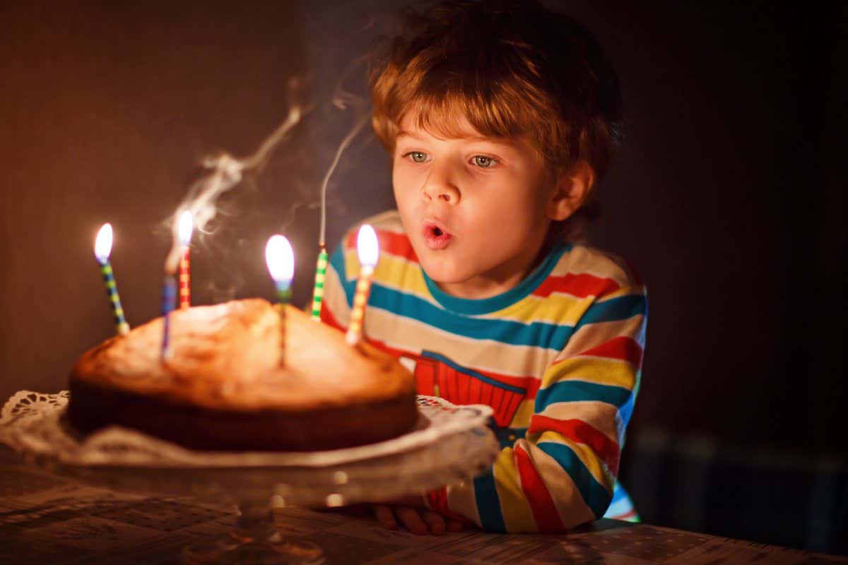 Happy little kid boy celebrating his birthday and blowing candles on homemade baked cake, indoor. Birthday party for children. Carefree childhood, anniversary, happiness. Five years old; Shutterstock ID 568106428; purchase_order: -; job: -; client: -; other: -