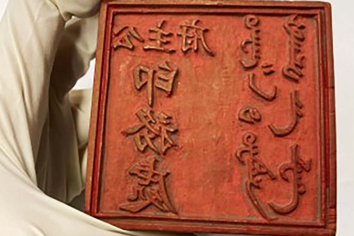 Stories of Paper Innovation Holding a Chinese woodblock from museums collection