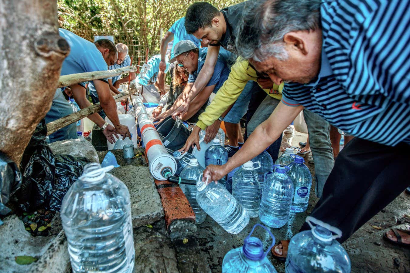 People in Cape Town, South Africa, refill water bottles at Newlands Spring in January 2018 amid the city's drought