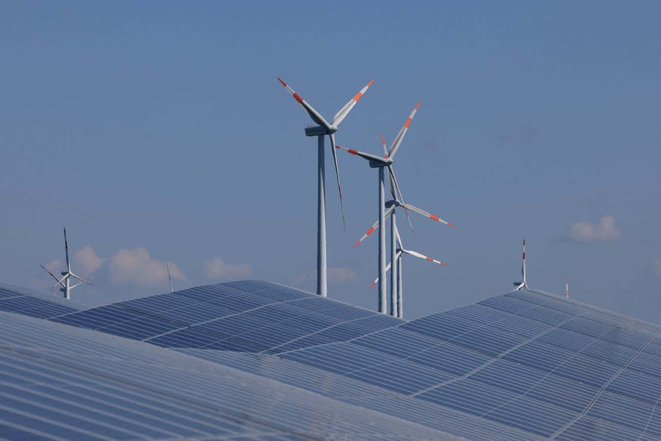 Solar panels and wind turbines at a new solar park near Prenzlau, Germany