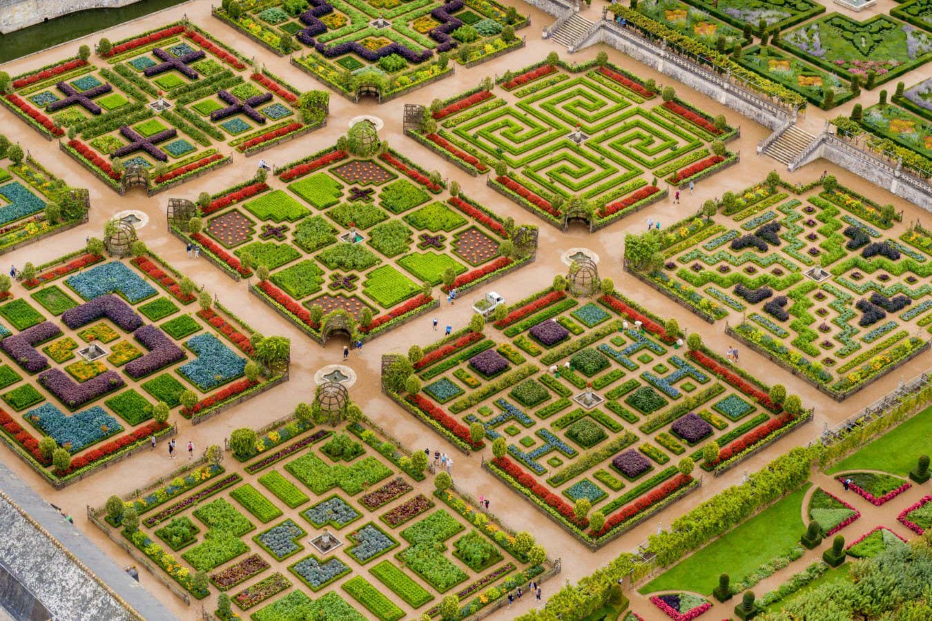 Organic gardening is an art form at the Ch??teau de Villandry. The original ch??teau was built in the 16th Century and sold in 1906 to Joachim Carvallo and Ann Coleman, who re-built the Renaissance garden based on classical designs. The garden today is managed by their great-great Grandson, Henri Carvallo, who lives with his family in the horse stables overlooking this horticultural masterpiece. The garden has ten full-time gardeners and attracts about 350,000 visitors per year. The central grid of nine square plots measures a little more than a hectare, with 90% planted in a rotating array of 90% seasonal vegetables, and the rest boxwood, and flowers. This picture was taken a week before the garden is harvested for their annual garden fair. The orange dots in the central square of the vegetable garden are pumpkins ? George Steinmetz, United States, Shortlist, Professional competition, Landscape, Sony World Photography Awards 2023