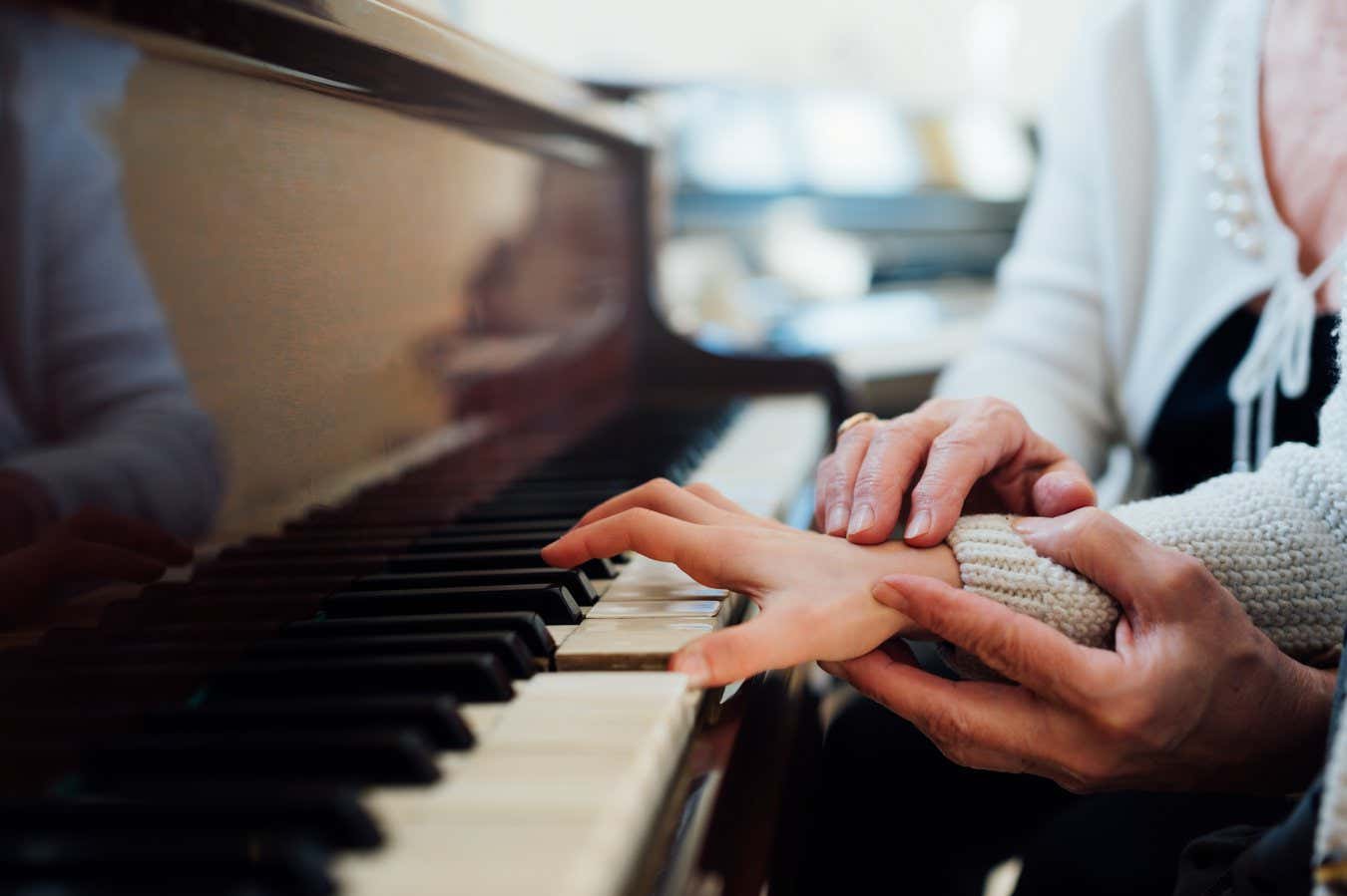 experienced hand of the old music teacher helps the child pupil; Shutterstock ID 379622230; purchase_order: -; job: -; client: -; other: -