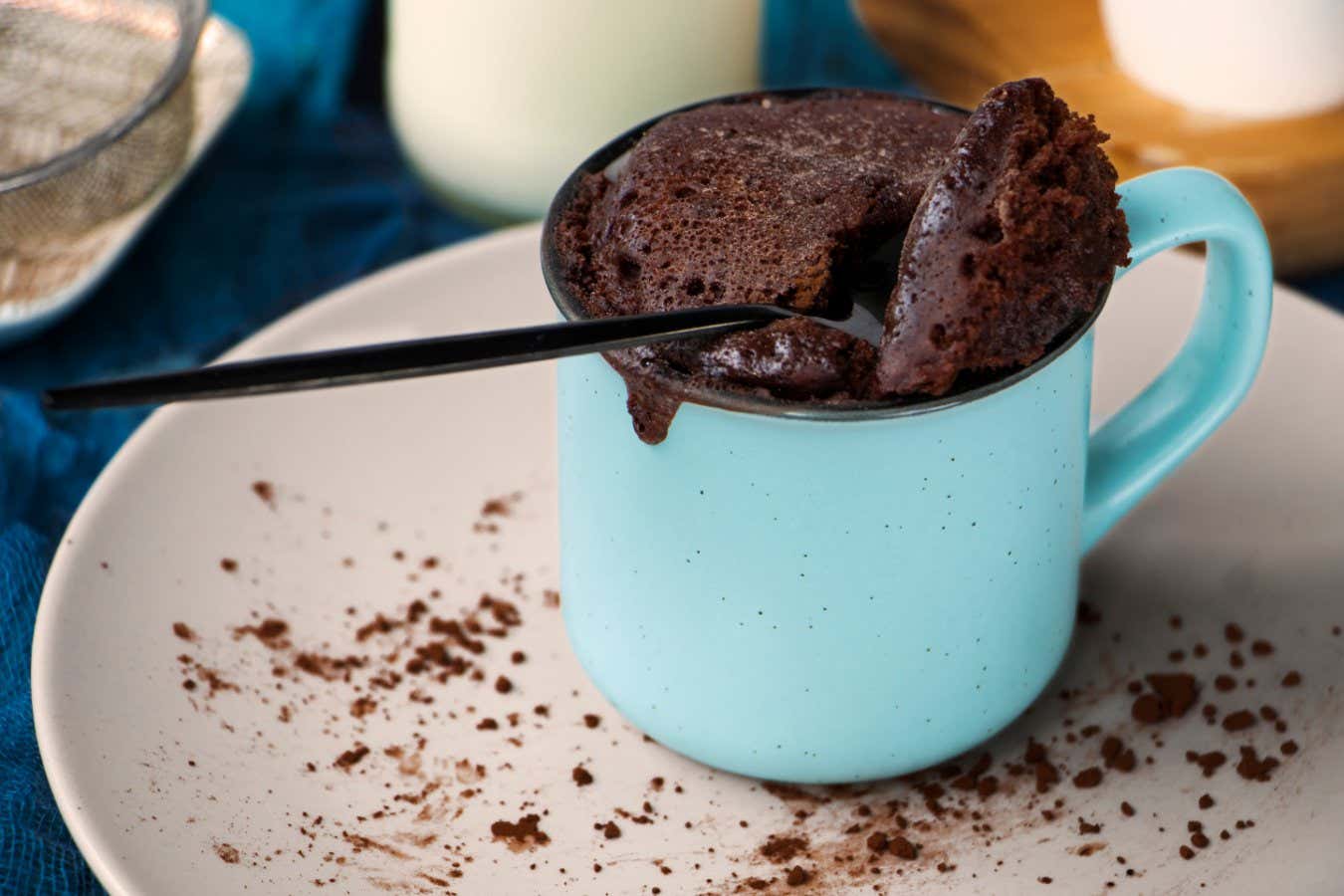 mugcake is microwaved. Homemade cupcake in a mug is on a plate. Chocolate brownie mug cake. Easy cooking concept, microwave baking. muffin chocolate. High quality photo; Shutterstock ID 2030585198; purchase_order: -; job: -; client: -; other: -