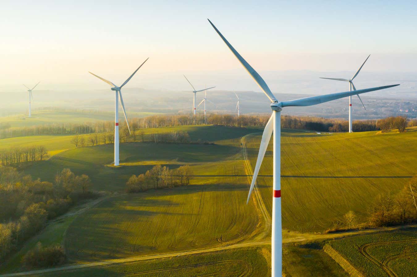 Panoramic view of wind farm or wind park, with high wind turbines for generation electricity with copy space. Green energy concept.; Shutterstock ID 1933377149; purchase_order: -; job: -; client: -; other: -