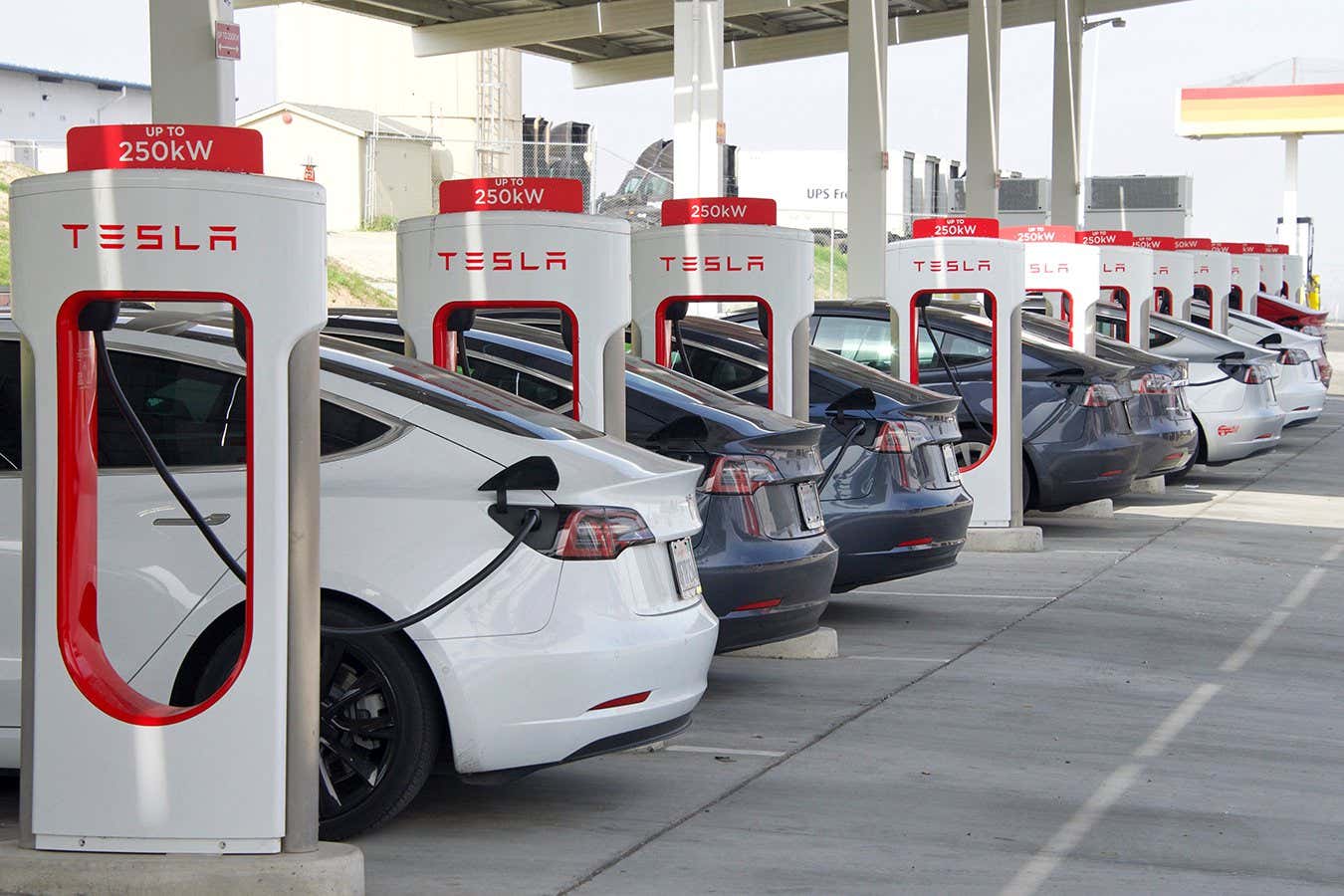 Kettleman City, CA - Jan 29, 2022: Many cars charging at a Tesla Supercharger station. Supercharger stations allow Tesla cars to be fast-charged at the network within a hour.