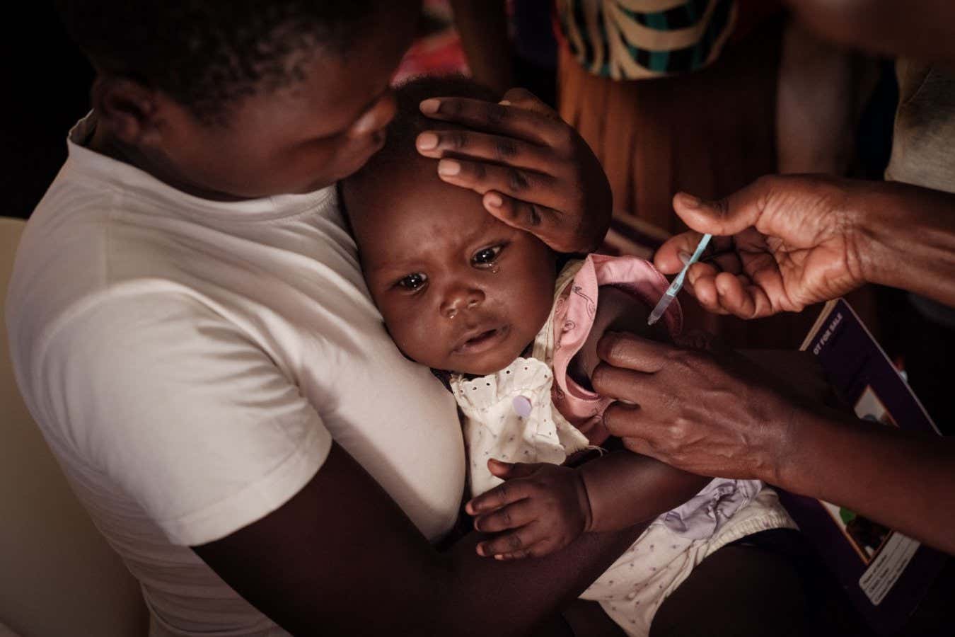A child receives the RTS malaria vaccine in Gisambai, Kenya, in March