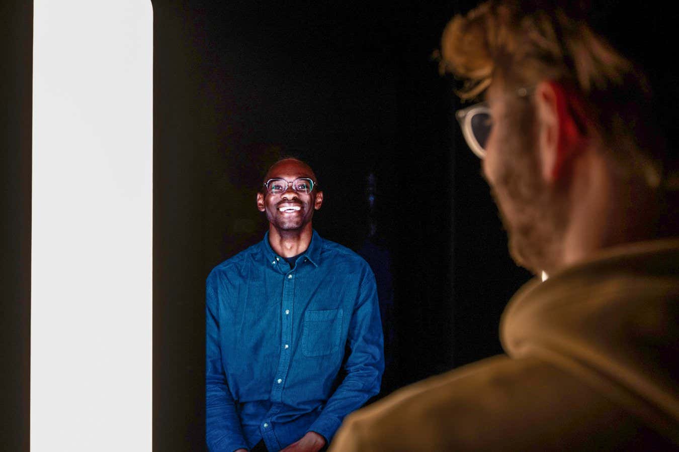Two people converse in a virtual meeting pod