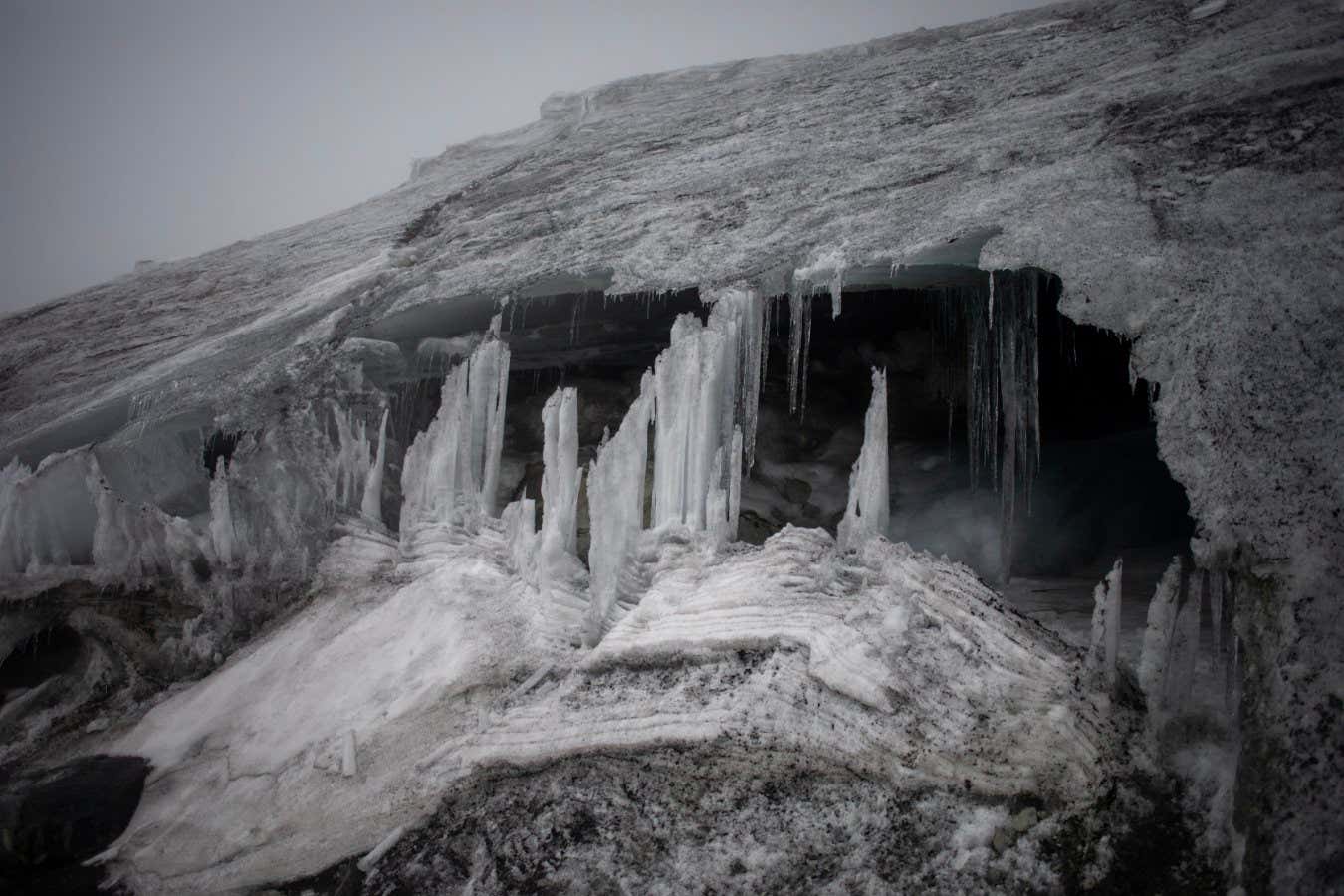 A deep cave cuts under the leading lip of the Stanely Glacier in the Rwenzori Mountains in Uganda