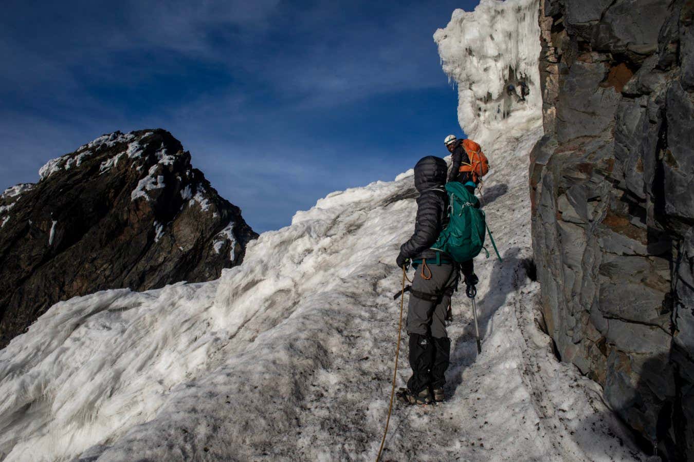 Enock Bwambale, deputy head guide for the Rwenzori Trekking Services, leads Alessandra Prentice and I up the high shoulder of the Stanley Glacier towards a cornice of ice that was once so big it forced the first successful summit team in 1905 to stand on each other's heads to get over it. Today, trekkers can high around it because the ice is so low.