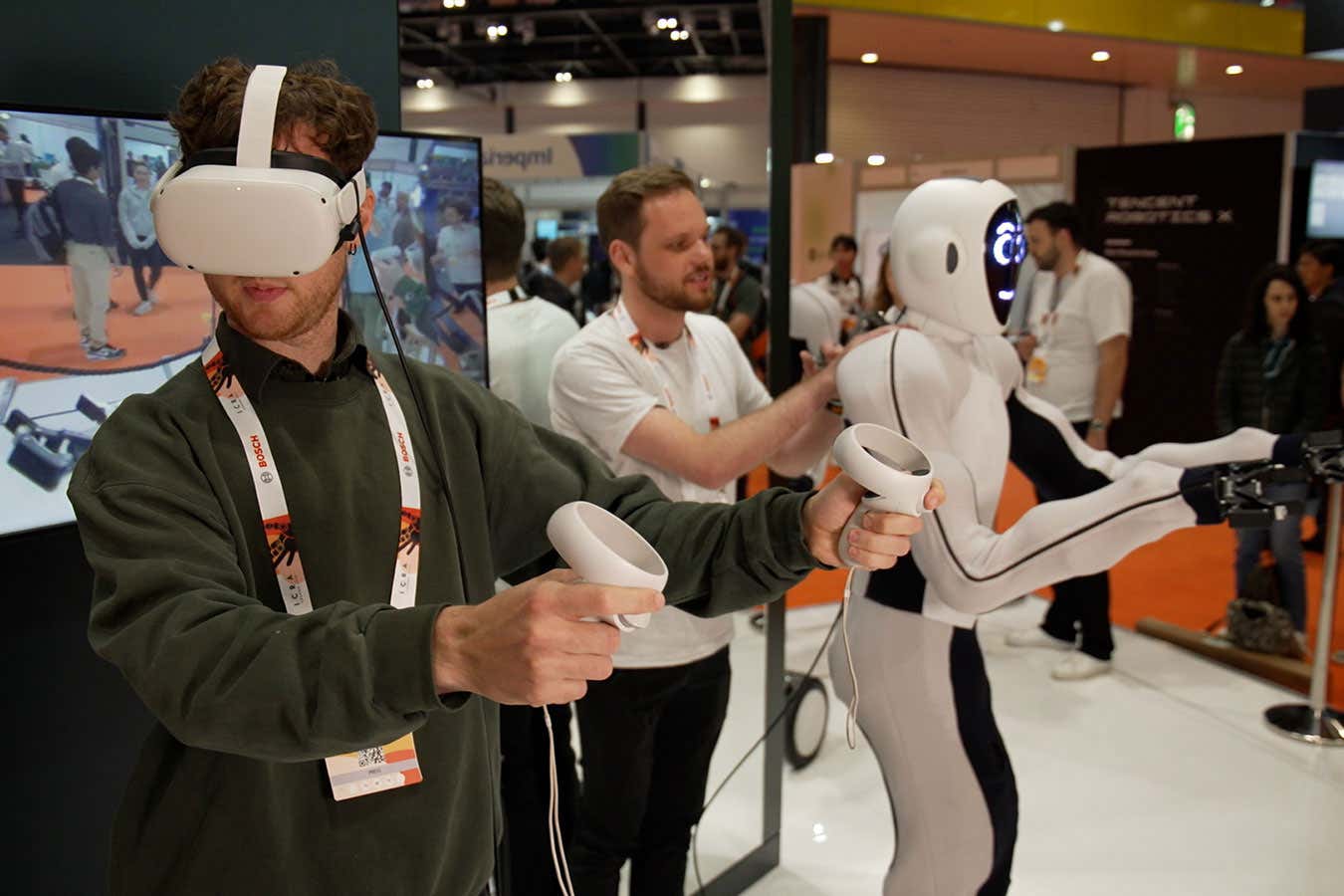 Alex Wilkins tests out EVE, a humanoid robot at ICRA