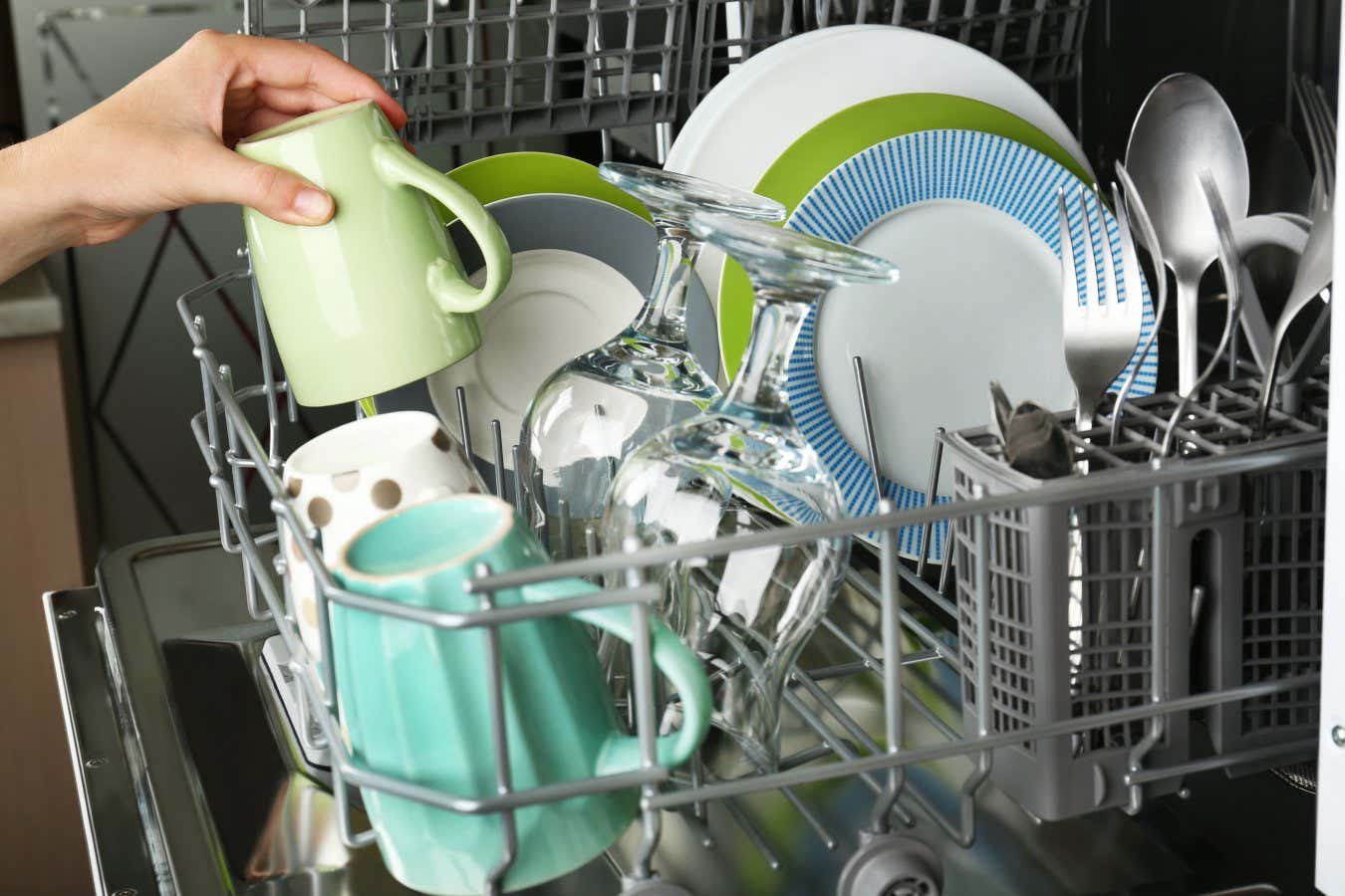 Open dishwasher with clean utensils in it; Shutterstock ID 218515030; purchase_order: -; job: -; client: -; other: -