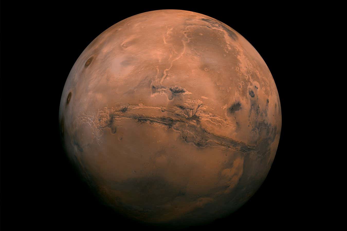 This mosaic of Mars is a compilation of images captured by the Viking Orbiter 1. The center of the scene shows the entire Valles Marineris canyon system, more than 2,000 miles (3,000 kilometers) long, 370 miles (600 kilometers) wide and 5 miles (8 kilometers) deep, extending from Noctis Labyrinthus, the arcuate system of graben to the west, to the chaotic terrain to the east.